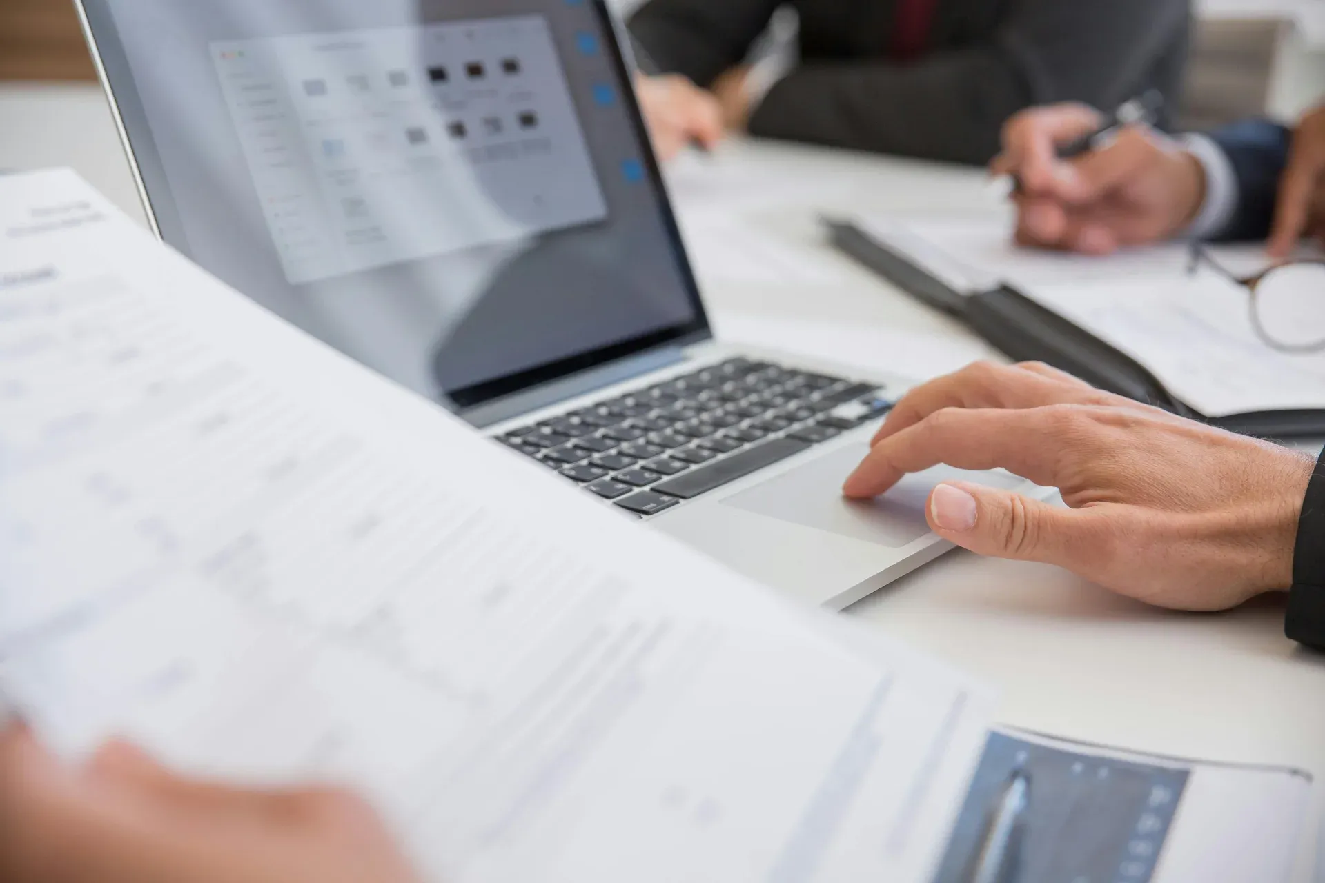 Business professional working on laptop during strategic consulting session